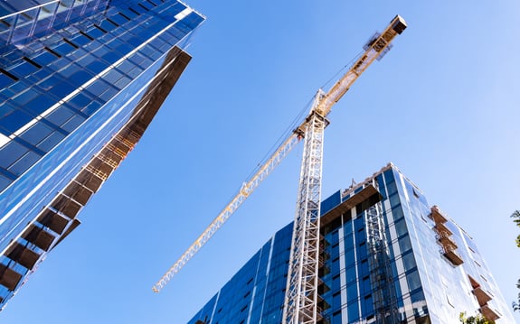 construction crane between skyscrapers