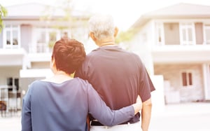 2 senior citizens looking at housing from outside