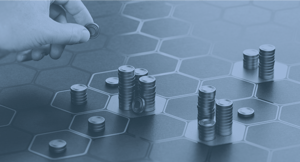 hand stacking towers of coins