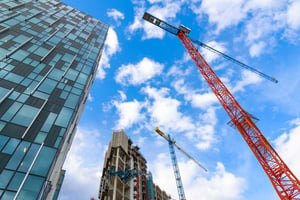 looking up at cranes and skyscrapers