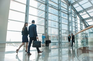 employees walking with each other in big office building hallway