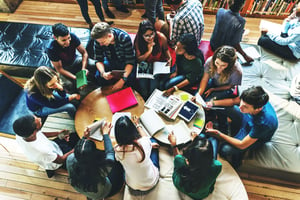 college students working on project around a table