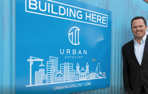 Erik Hayden in front of Urban Catalyst sign