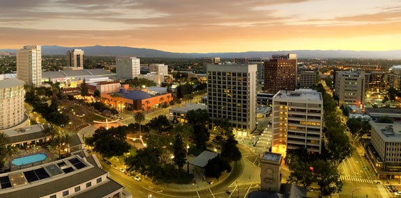 San Jose buildings with mountains in the background at dusk