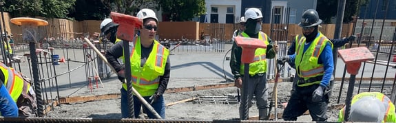 construction workers pouring concrete