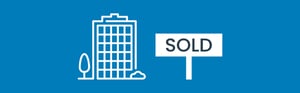 sold sign in front of office building