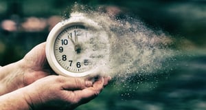 clock in man's hands that is disinegrating